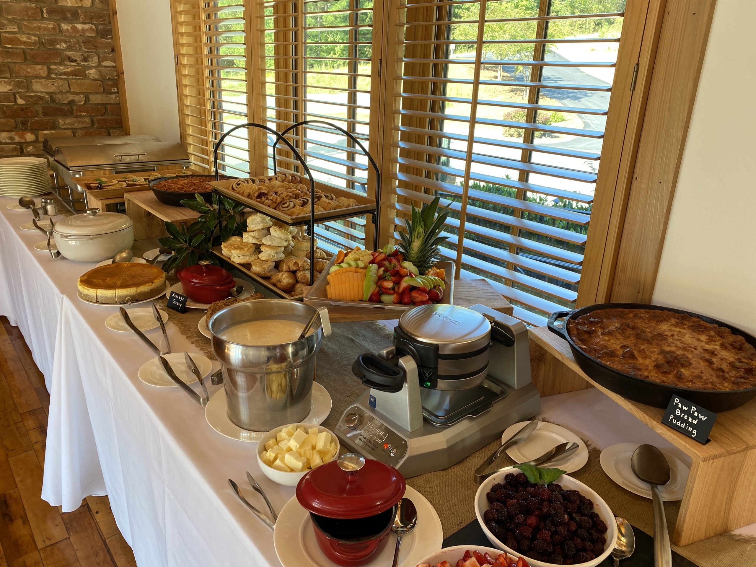 Brunch setup with pastries, fruit, and more
